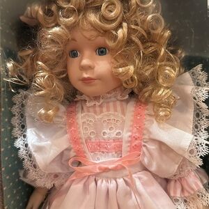 *New mint condition vintage porcelain doll in box with stand.Pink Lace dress
